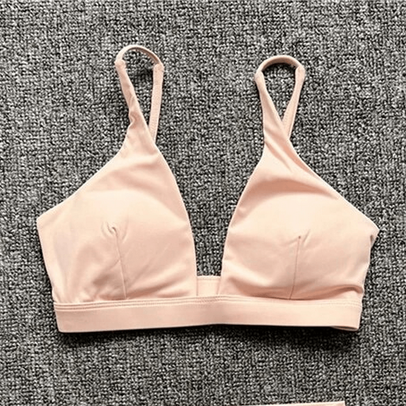 Women's Quick-Drying Sports Bra with Deep Neckline in solid pink, breathable nylon, perfect for yoga and active pursuits.